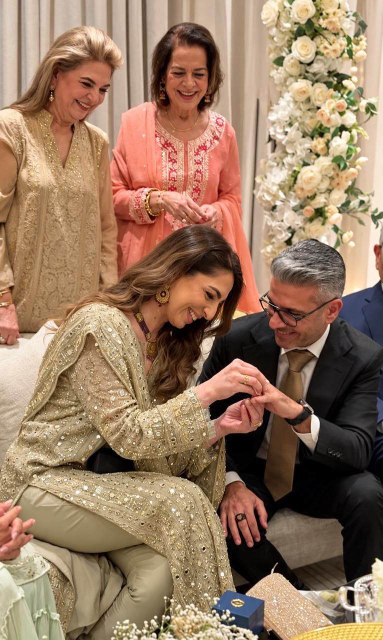 The engagement ring moment — Rahim and Nadia in traditional dress, with family looking on